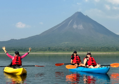 A woman kayaking on calm turquoise water in Costa Rica
