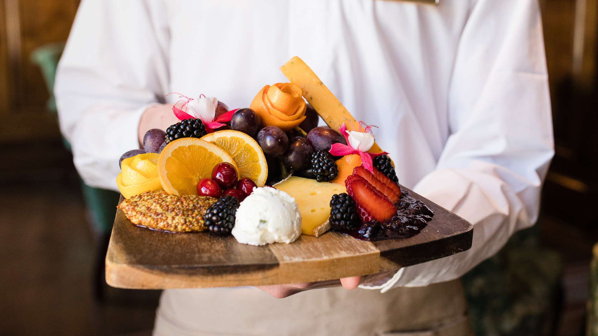 Beautifully presented charcuterie board with fresh fruit and cheese at a luxury retreat