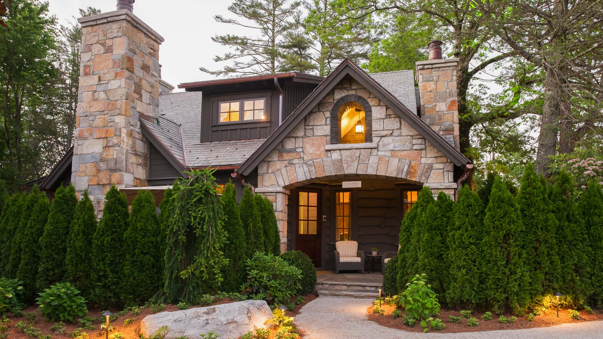 Elegant mountain retreat cottages with warm lighting at dusk