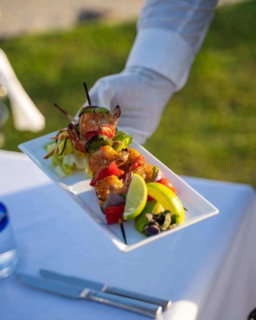 A chef plating a colorful island dish during an interactive cooking experience