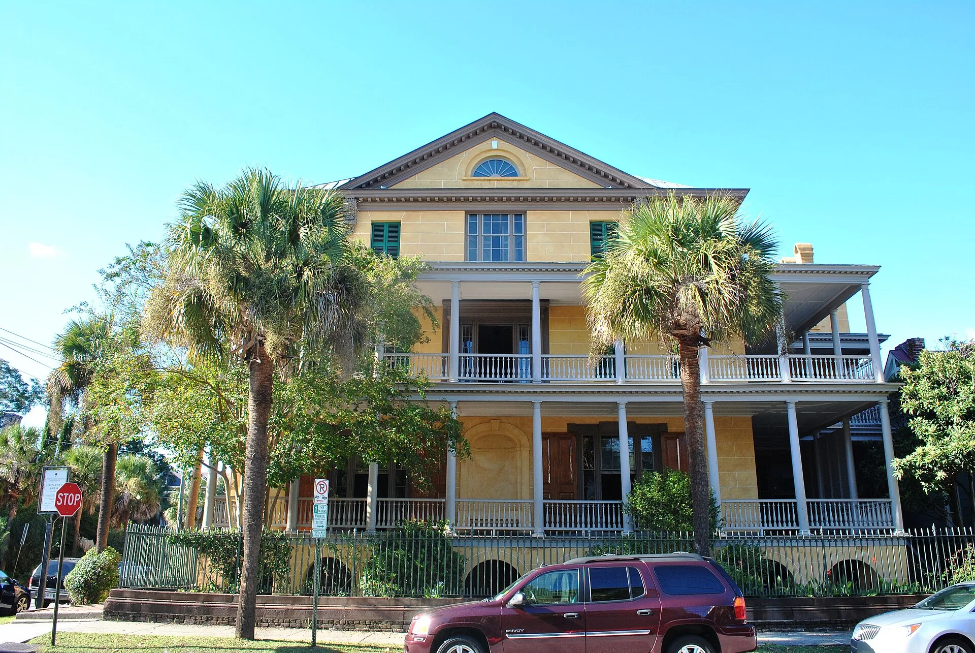A quiet historic street of restored houses with porches and gas lamps in the American South