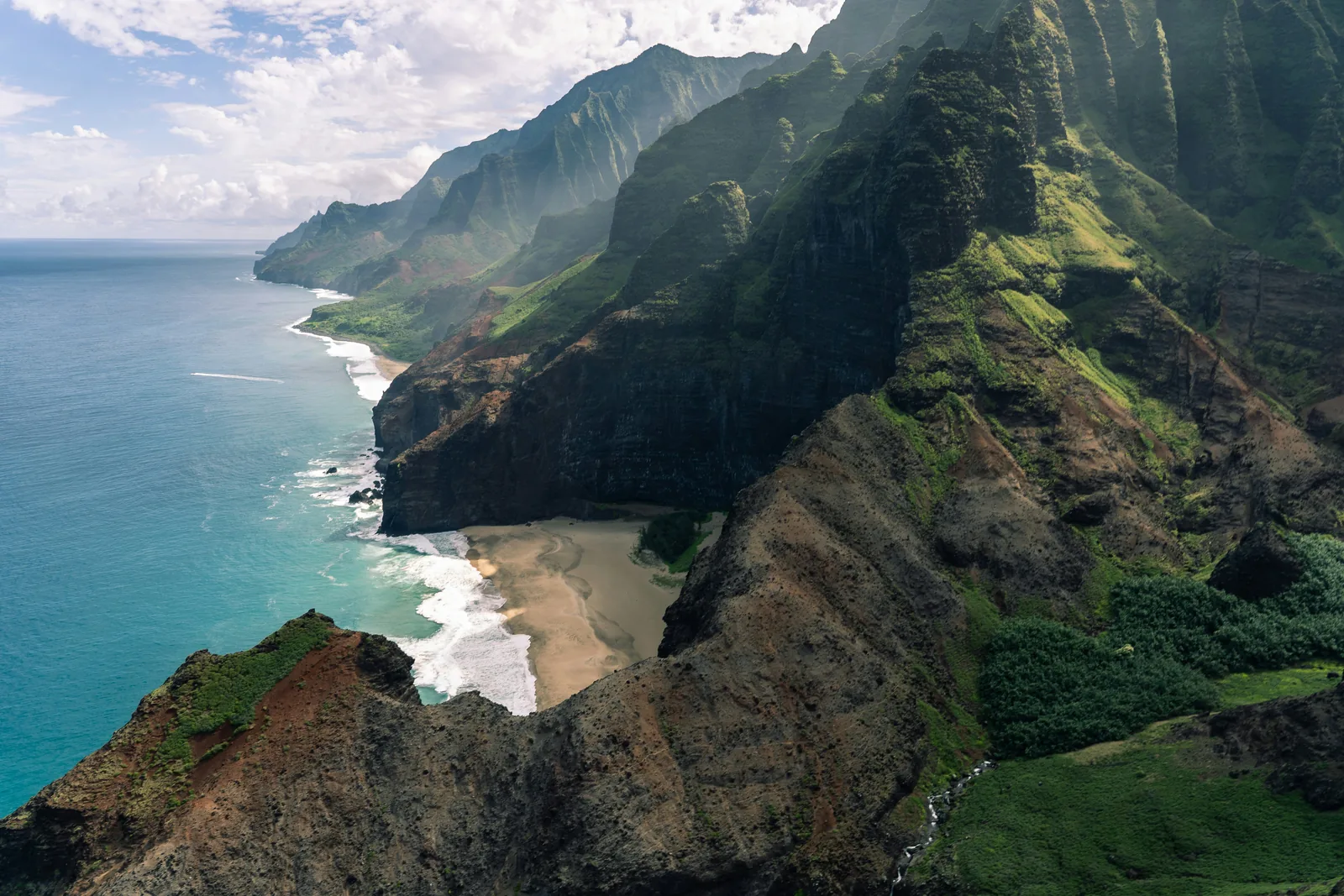 The green sea cliffs of the Na Pali Coast on Kauai above the Pacific